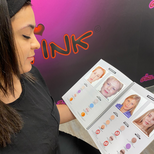 PMU artist reading the Beyond the Epidermis color theory and corrections workbook at Girlz Ink studio