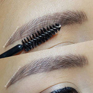 Healed powder brows created with a 50/50 mix of Classic Brown and Cappuccino pigments by Angela Lin, shown close-up with a spoolie brush for texture detail.