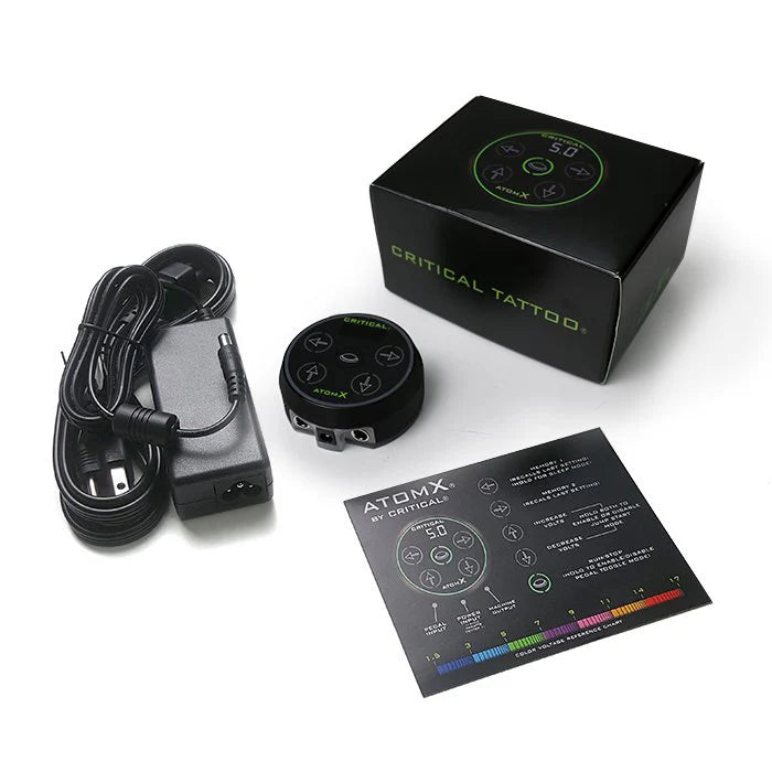 Critical AtomX Power Supply Kit – professional digital PMU and tattoo power unit with magnetic base, power adapter, and voltage guide. Features color-coded voltage display from 1.5V to 17V for precise, consistent performance.
