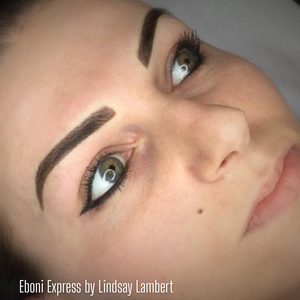 Close-up of freshly done brows using Eboni Express from the Li Pigments Aqua collection by artist Lindsay Lambert. The pigment delivers a deep, cool-toned espresso brown ideal for clients wanting bold, defined, and natural-looking healed PMU results.