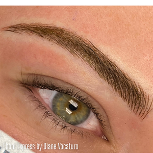 Close-up of a healed brow created with Eboni Express from the Li Pigments Aqua collection by artist Diane Vocaturro. The pigment delivers a deep, neutral brown-black tone ideal for clients seeking defined yet natural-looking permanent brows.