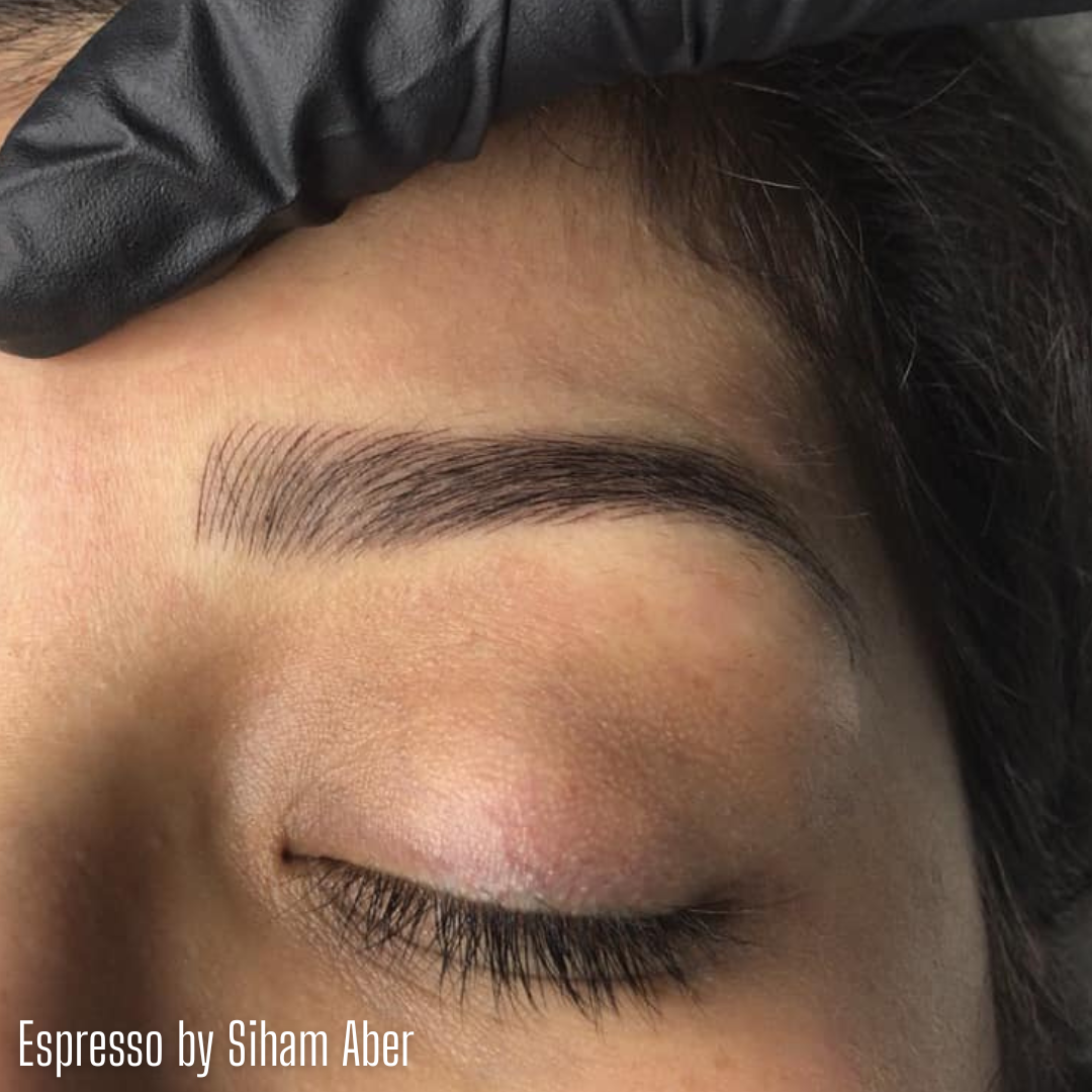 Close-up of brow microblading in progress using Espresso from the Li Pigments Aqua collection by artist Siham Aber. The pigment provides a balanced, cool-toned dark brown ideal for creating natural, defined hair strokes in permanent makeup procedures