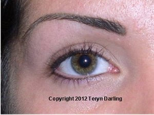 Close-up of an eye showing unhealed permanent makeup eyebrow and eyeliner.”