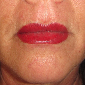 Lip color correction using Luscious Raspberry with Neon Orange modifier by Julie Martinek-Scimeca, showing bold red permanent makeup lip pigmentation on a mature client.