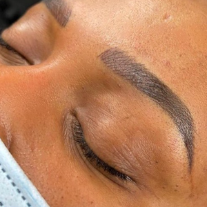 Straight brow permanent makeup results created with Raven pigment, showing controlled shape, balanced density, and healed color retention.