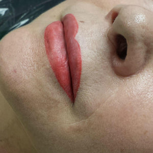 Freshly treated lips using Li Pigments Aqua Global Red Hot lip pigment, showing bold red lip blush results immediately after permanent makeup application by Teryn Darling.