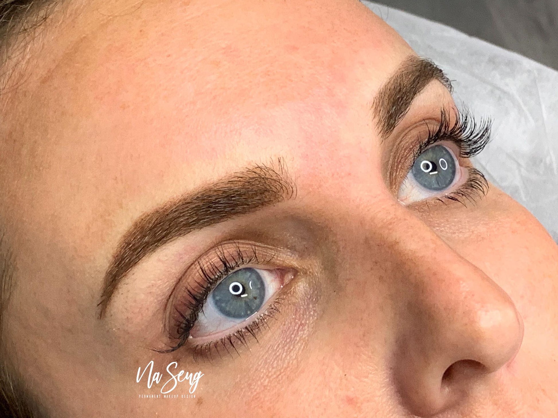 PMU brows done using Saddle Brown as a base with Wild Mustang layered on top, creating a soft yet defined look by Na Seng.