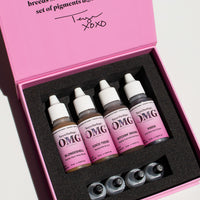 Open box of Teryn Darling’s OMG Brow Pigments by Li Pigments featuring Blondeshell, Coco Teese, Bitchin’ Brown, and Vixen bottles arranged inside a pink branded box.