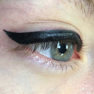 Close-up of an eye showing winged permanent makeup eyeliner