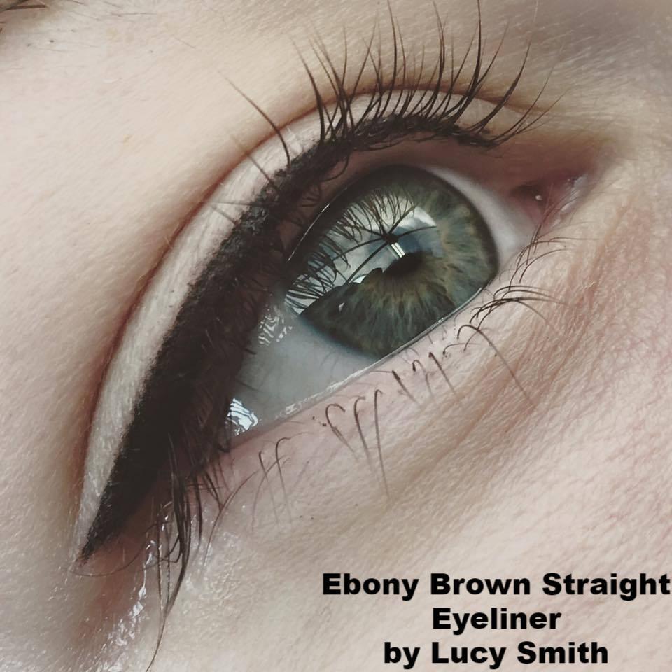 Close-up of eyeliner tattoo done with Aqua Ebony Brown on a client with green eyes, by Lucy Smith.