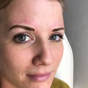 Close-up of freshly tattooed eyebrows using Taupe from the Li Pigments Aqua collection by Toni Bathurst. This cool, medium ash-brown pigment creates natural, balanced permanent makeup brows ideal for clients with fair to light skin tones and neutral to cool undertones.