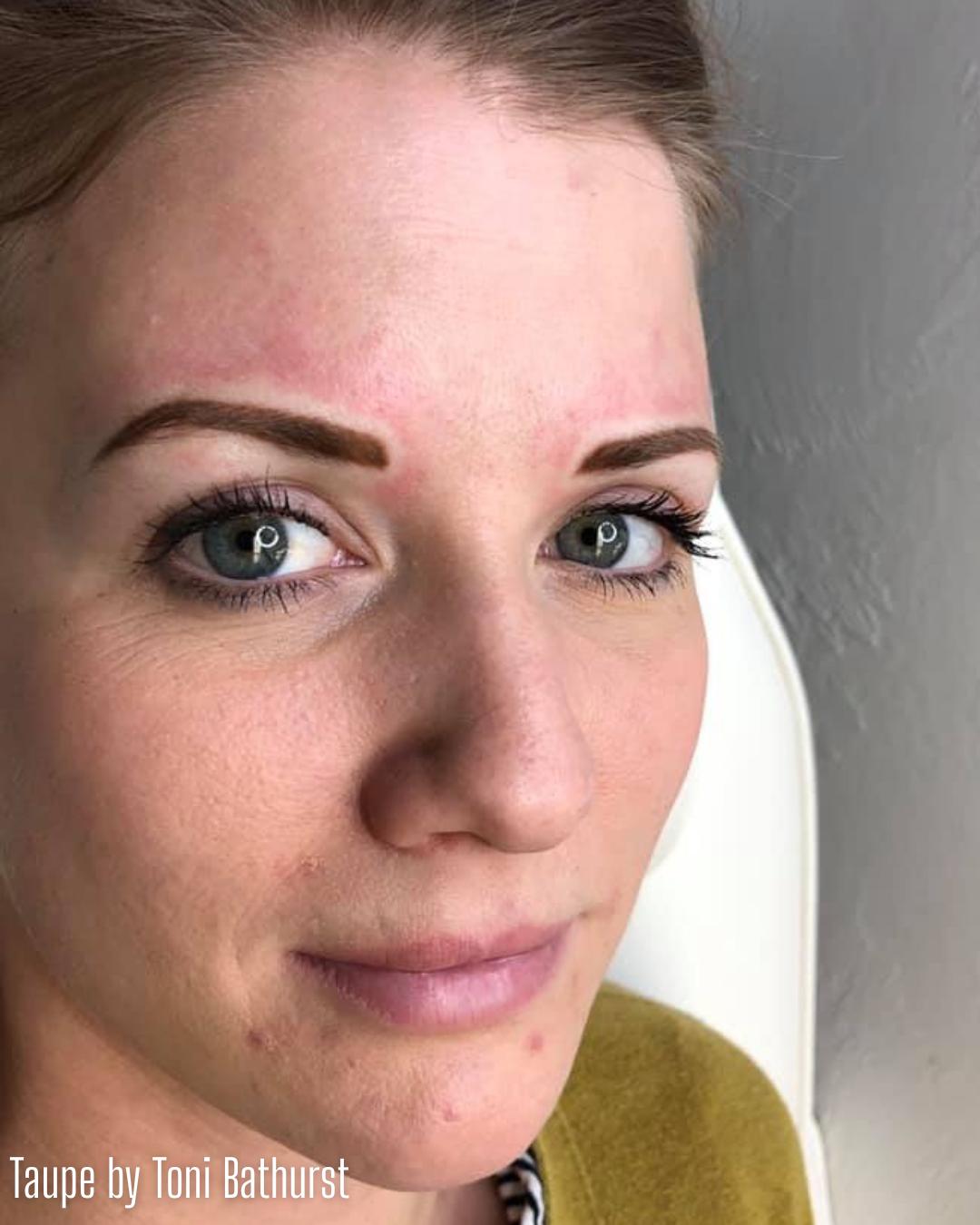 Close-up of freshly tattooed eyebrows using Taupe from the Li Pigments Aqua collection by Toni Bathurst. This cool, medium ash-brown pigment creates natural, balanced permanent makeup brows ideal for clients with fair to light skin tones and neutral to cool undertones.