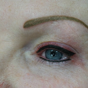 Eyebrows mid-correction using Aqua Yellow Olive Mode pigment to neutralize old blue tones.

