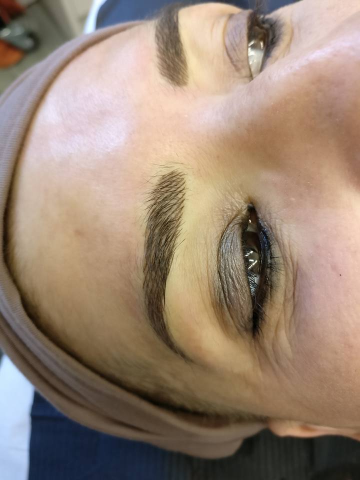 Healed eyebrow tattoo using Eboni Express pigment by Naomi Waite, showing rich brown color and soft finish.