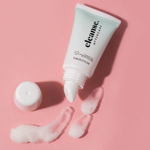 Open tube of Girlz Ink Cleanse Aftercare with gentle foam cleanser on a pink background, showing texture and packaging for PMU and tattoo healing.