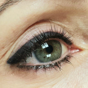 Healed permanent eyeliner using Li Pigments Black Diamond from the Aqua Line by Teryn Darling of Girlz Ink, shown one year post-procedure with smooth black retention and crisp lash line definition.