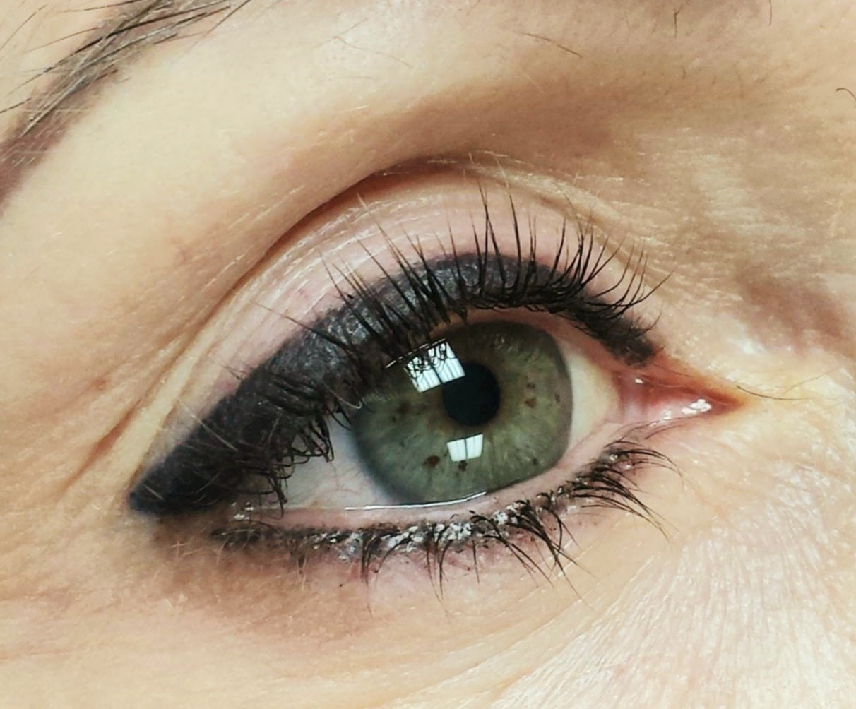 Healed permanent eyeliner using Li Pigments Black Diamond from the Aqua Line by Teryn Darling of Girlz Ink, shown one year post-procedure with smooth black retention and crisp lash line definition.