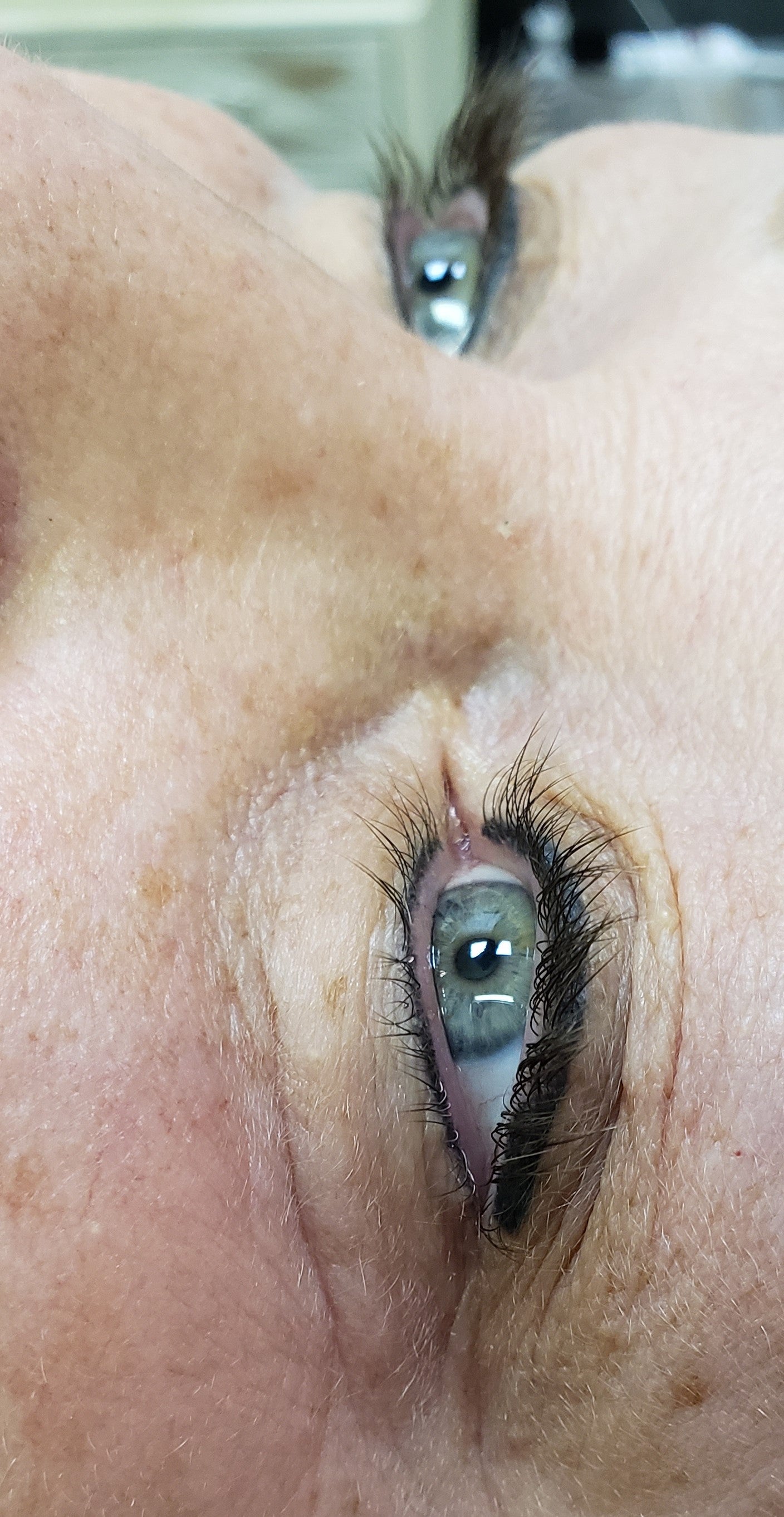 Healed permanent eyeliner ten years after application using Li Pigments Ultra Black pigment, showing excellent color retention and definition along the lash line.